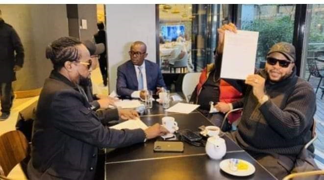 JB Mpiana brandissant un exemplaire du contrat signé avec Amadou D. (DR)